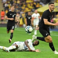 New Zealand defender Michael Boxall (right), seen facing Sweden during a recent friendly, was the target of a racial epithet during the All Whites\' game against Qatar on Monday. | AFP-JIJI