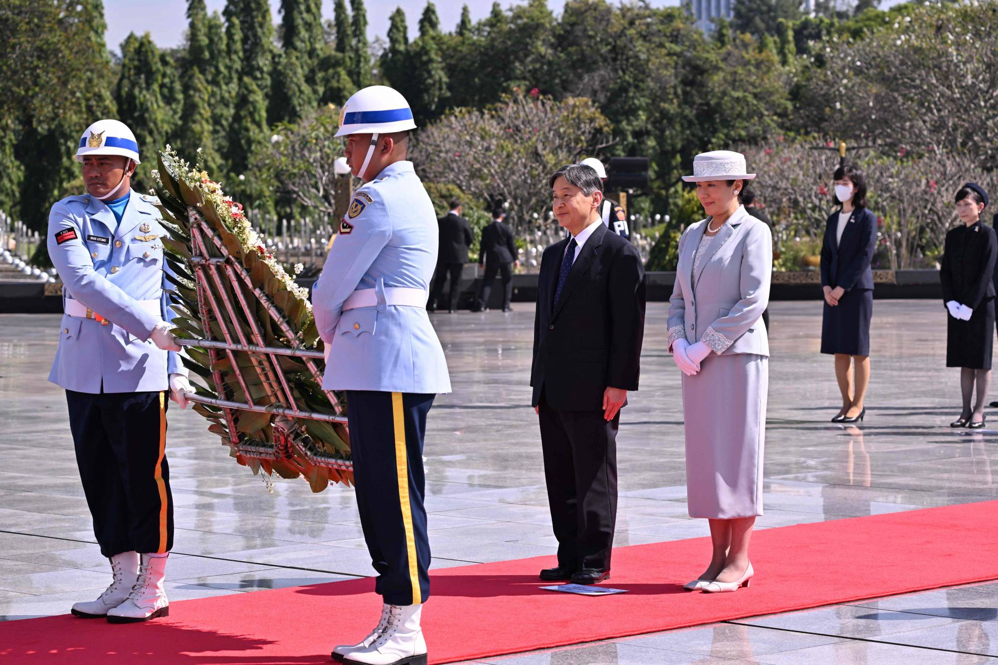 Emperor Naruhito and Empress Masako prepare to lay a wreath during a ceremony at the Kalibata Heroes Cemetery in Jakarta on Tuesday. | POOL / VIA AFP-JIJI