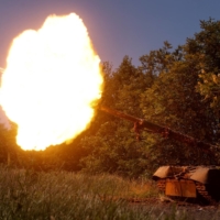 Ukrainian servicemen fire from a T-80 main battle tank captured earlier from Russian troops, in a field near the front line town of Bakhmut. | RADIO FREE EUROPE / RADIO LIBERTY / VIA REUTERS   