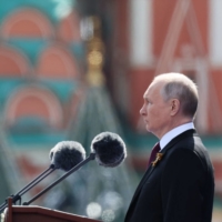 Russian President Vladimir Putin gives a speech during the Victory Day military parade at Red Square in central Moscow on May 9. | SPUTNIK / AFP / GETTY IMAGES / VIA BLOOMBERG