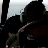 The pilot of a Royal Canadian Air Force CP-140 Aurora maritime surveillance aircraft of 14 Wing flies a search pattern for the missing OceanGate submersible, which had been carrying five people to explore the wreck of the sunken SS Titanic, in the Atlantic Ocean off Newfoundland, Canada, on Tuesday. | CANADIAN FORCES / VIA REUTERS 
