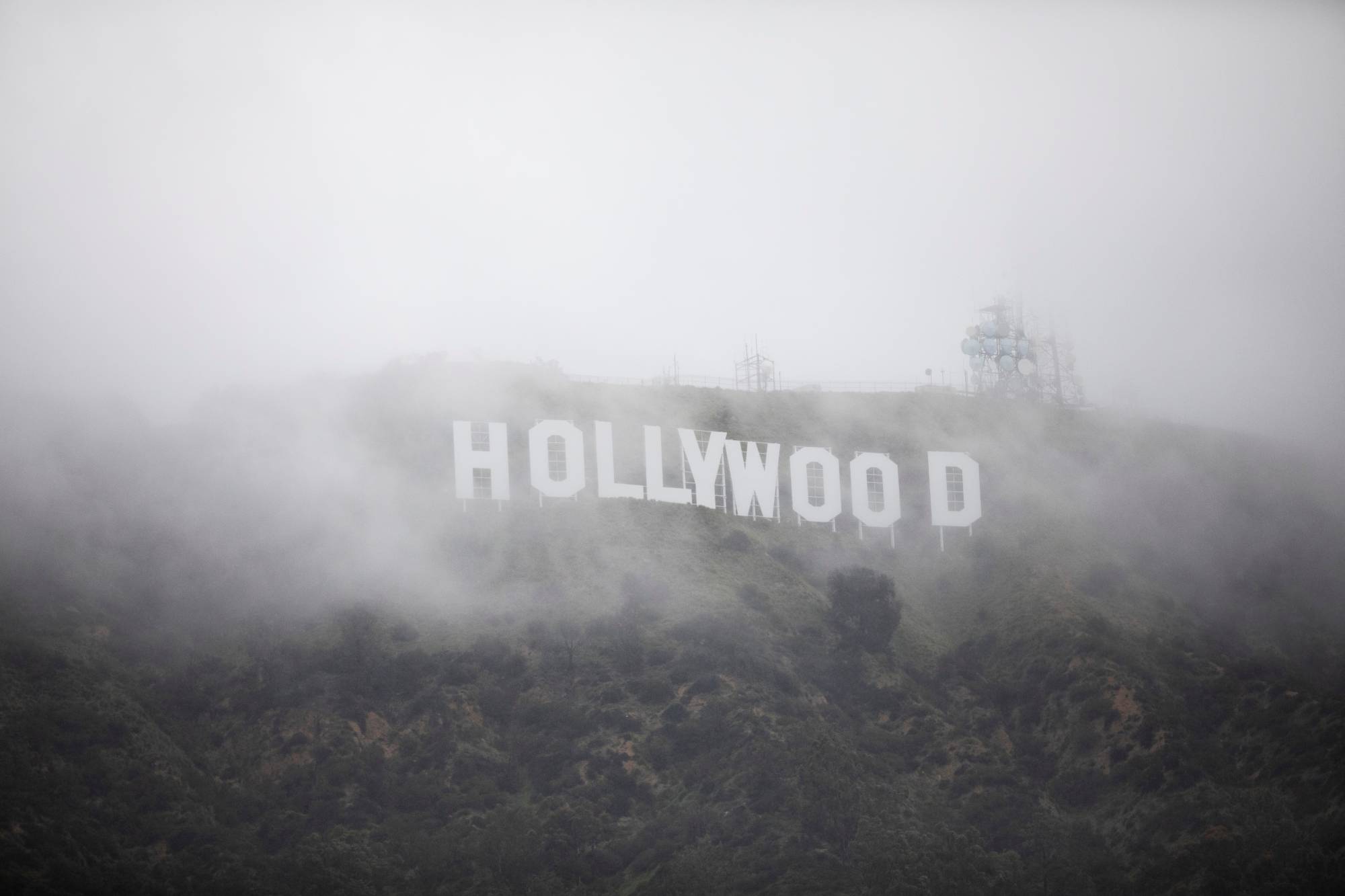 The Hollywood sign is seen through a mix of fog and snow during a rare winter storm in the Los Angeles area in February. American films have been getting a slightly chilly reception in Japan over the past 20 years, according to critic Hiroo Otaka. | REUTERS