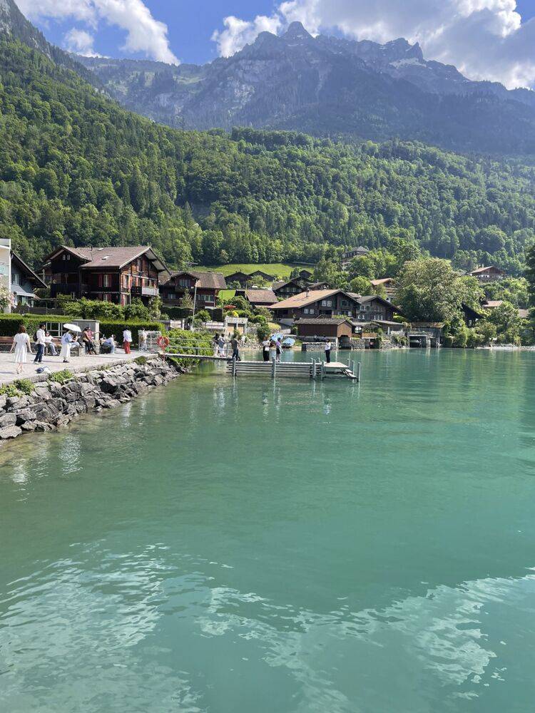 Tourists roam the location for 'Crash Landing on You' in Lake Brienz, Iseltwald. | BLOOMBERG