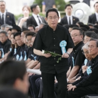 Prime Minister Fumio Kishida walks to lay a flower on Friday during a ceremony held in Itoman, Okinawa Prefecture, to mourn victims of the fierce ground battle in the final phase of World War II 78 years ago. | KYODO