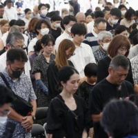 Participants in a ceremony held in Itoman, Okinawa Prefecture, on Friday observe a minute of silence for the over 200,000 victims who died in the Battle of Okinawa 78 years ago. | KYODO
