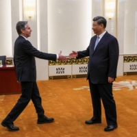 Chinese President Xi Jinping greets U.S. Secretary of State Antony Blinken in the Great Hall of the People in Beijing on Monday. | REUTERS