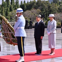Emperor Naruhito and Empress Masako participate in a wreath-laying ceremony at the Kalibata national heroes cemetery in Jakarta on June 20. | POOL / VIA REUTERS