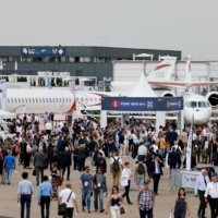 Visitors attend the International Paris Air Show at the Paris-Le Bourget Airport, France, on Monday. | POOL / VIA REUTERS