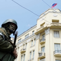 A member of the Wagner Group stands guard on a street in the city of Rostov-on-Don, Russia, on Saturday. | AFP-JIJI