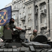 Wagner Group fighters on top of a tank in Rostov-on-Don, Russia, on Saturday | REUTERS