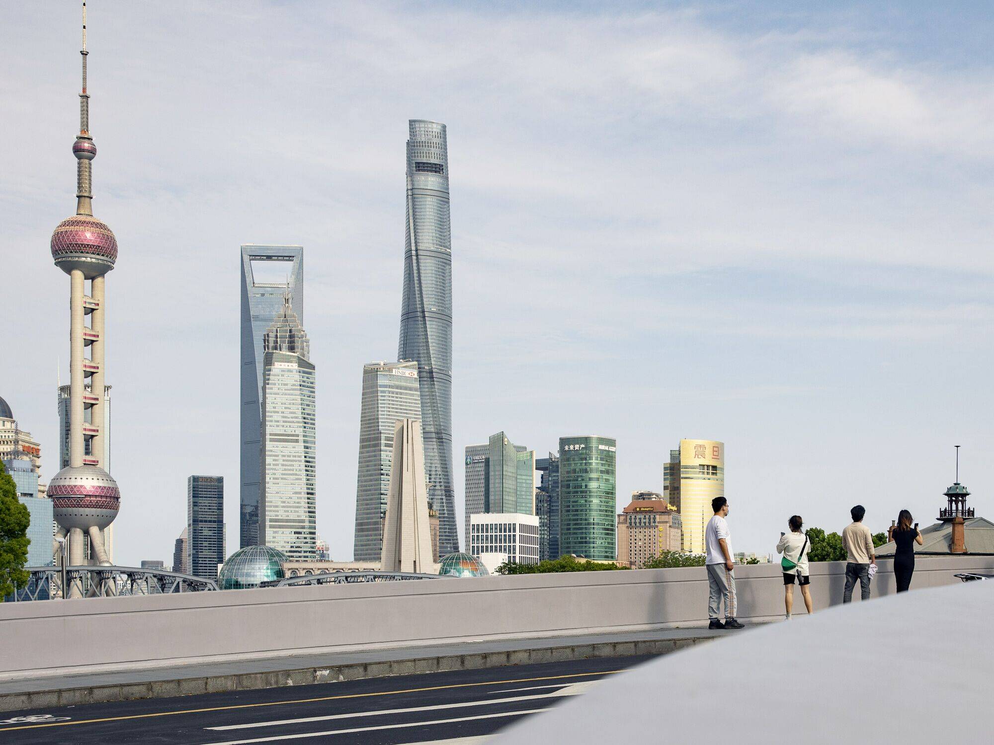 Residents stand along a bridge near the Bund in Shanghai in May 2022. | BLOOMBERG