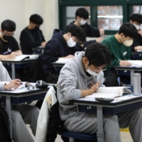 South Korean students take their College Scholastic Ability Test at a school in Seoul in November 2022. | POOL / VIA REUTERS
