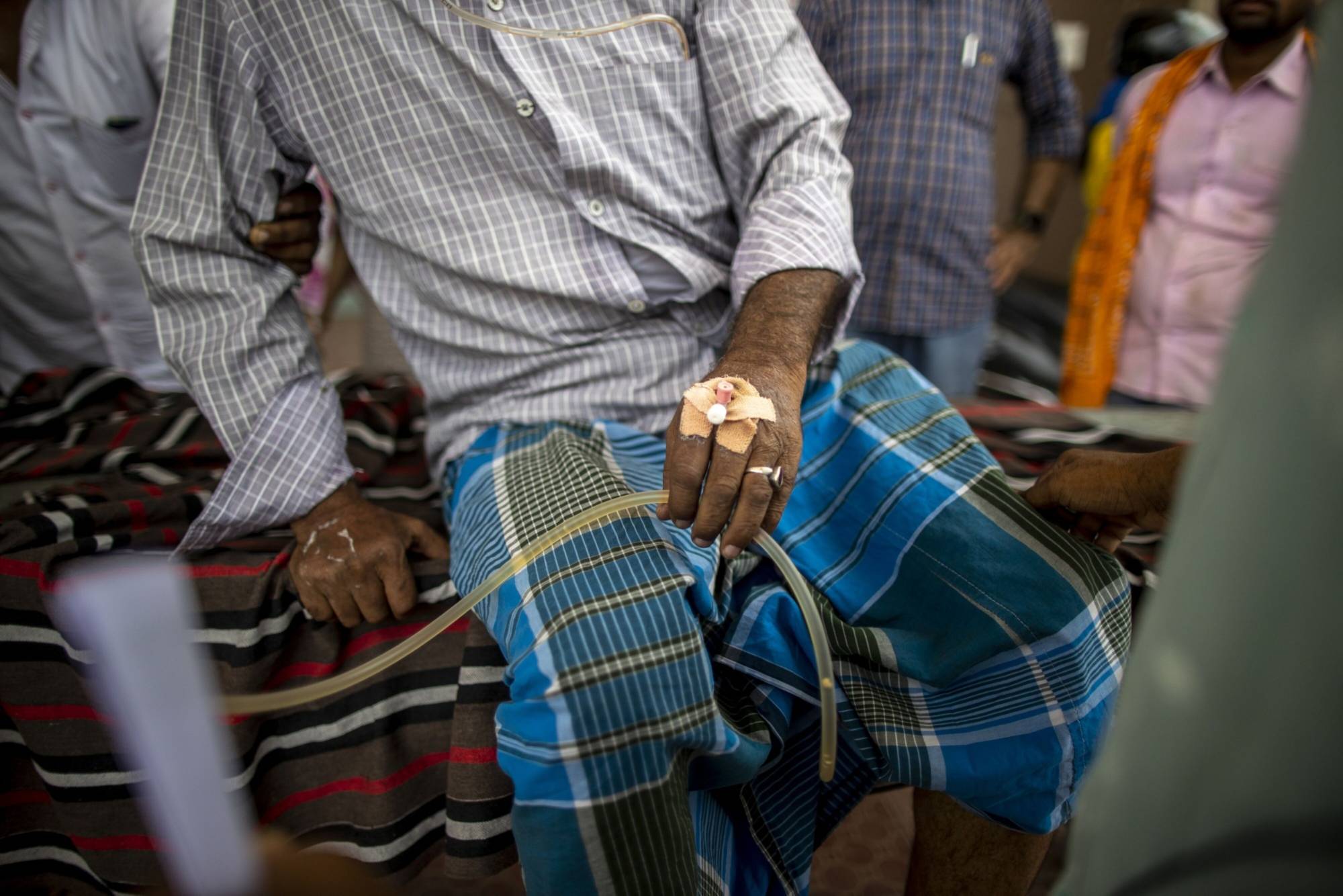A patient complaining of heatstroke symptoms waits for further testing at Nalanda Medical College and Hospital in Patna on Thursday. | Bloomberg