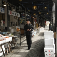 A visitor at Nijo fish market in Sapporo in April. The price of fish in Japan had risen 14.8% in May compared to a year before. | BLOOMBERG