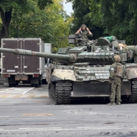 Fighters of the Wagner private mercenary group patrol a street in the Russian city of Rostov-on-Don on Saturday.  | REUTERS