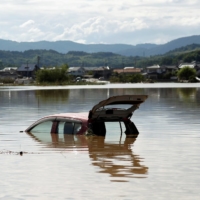 A car is submerged in a flooded area of Kurashiki, Okayama Prefecture, in 2018. As the climate warms, mountainous regions will get more extreme rainfall than previously thought, and more of the dangers that come with it, according to a study published on Wednesday, in the journal Nature. | REUTERS