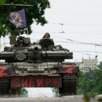 Members of Wagner group sit on top of a tank in a street in the city of Rostov-on-Don on Saturday. | AFP-JIJI