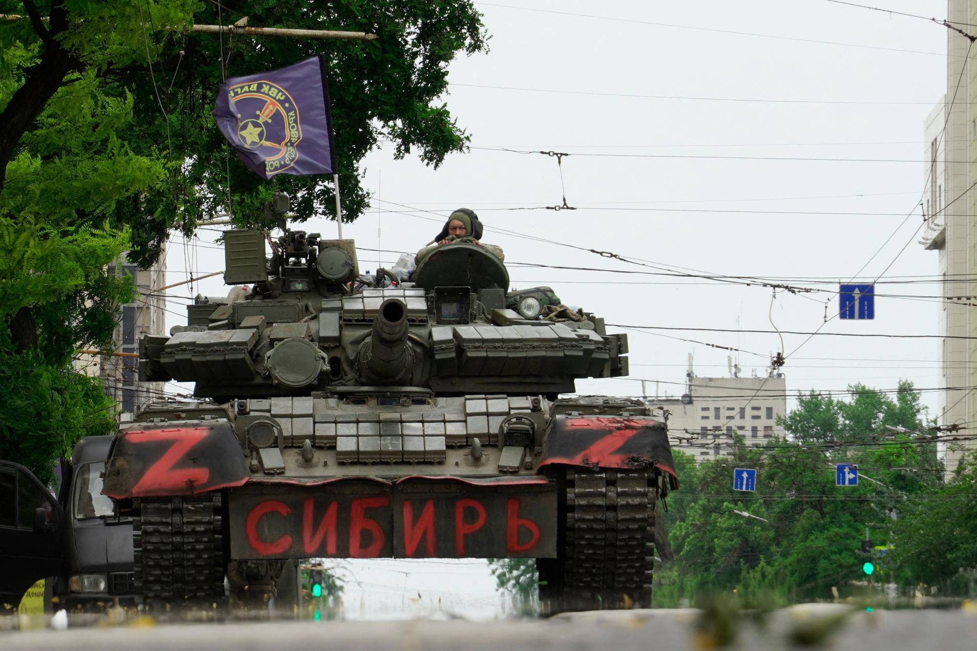 Members of Wagner group sit on top of a tank in a street in the city of Rostov-on-Don on Saturday. | AFP-Jiji