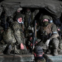 Wagner fighters pull out of the headquarters of the Southern Military District to return to base, in the city of Rostov-on-Don, Russia, on Saturday. | REUTERS