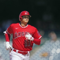 The Angels\' Shohei Ohtani rounds the bases after hitting his 29th home run of the season during a loss against the White Sox in Anaheim, California, on Thursday. | KYODO