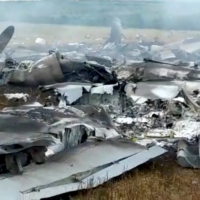 Debris of a downed Russian military plane, purportedly shot down by Wagner troops, in a field near Bugaevka, Russia, on June 24, in this screengrab obtained from a social media video. | VIA REUTERS