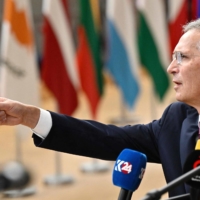 NATO Secretary-General Jens Stoltenberg talks to reporters as he arrives for a European Council Summit, at EU headquarters in Brussels on Thursday. | AFP-JIJI