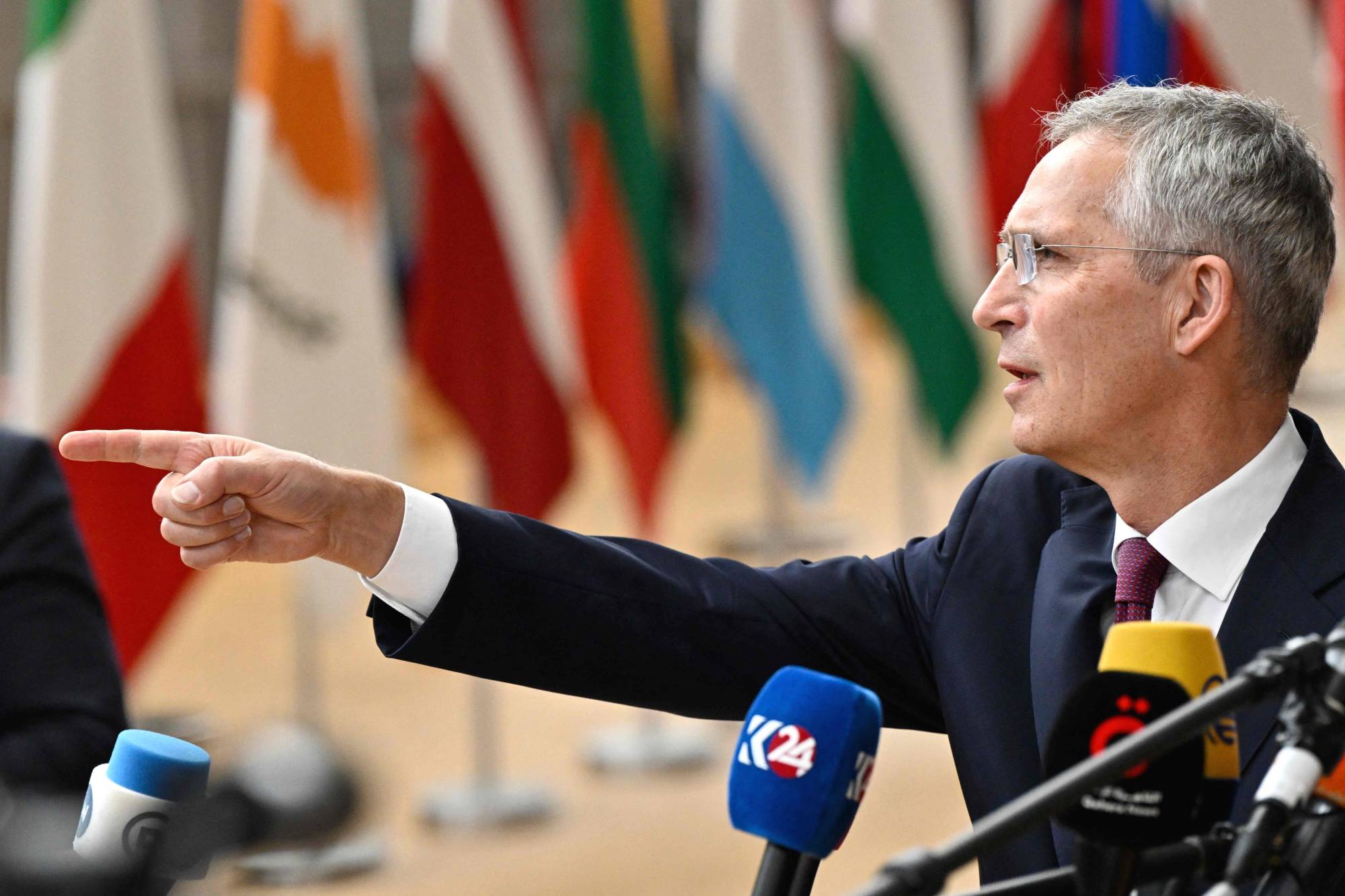 NATO Secretary-General Jens Stoltenberg talks to reporters as he arrives for a European Council Summit, at EU headquarters in Brussels on Thursday. | AFP-JIJI