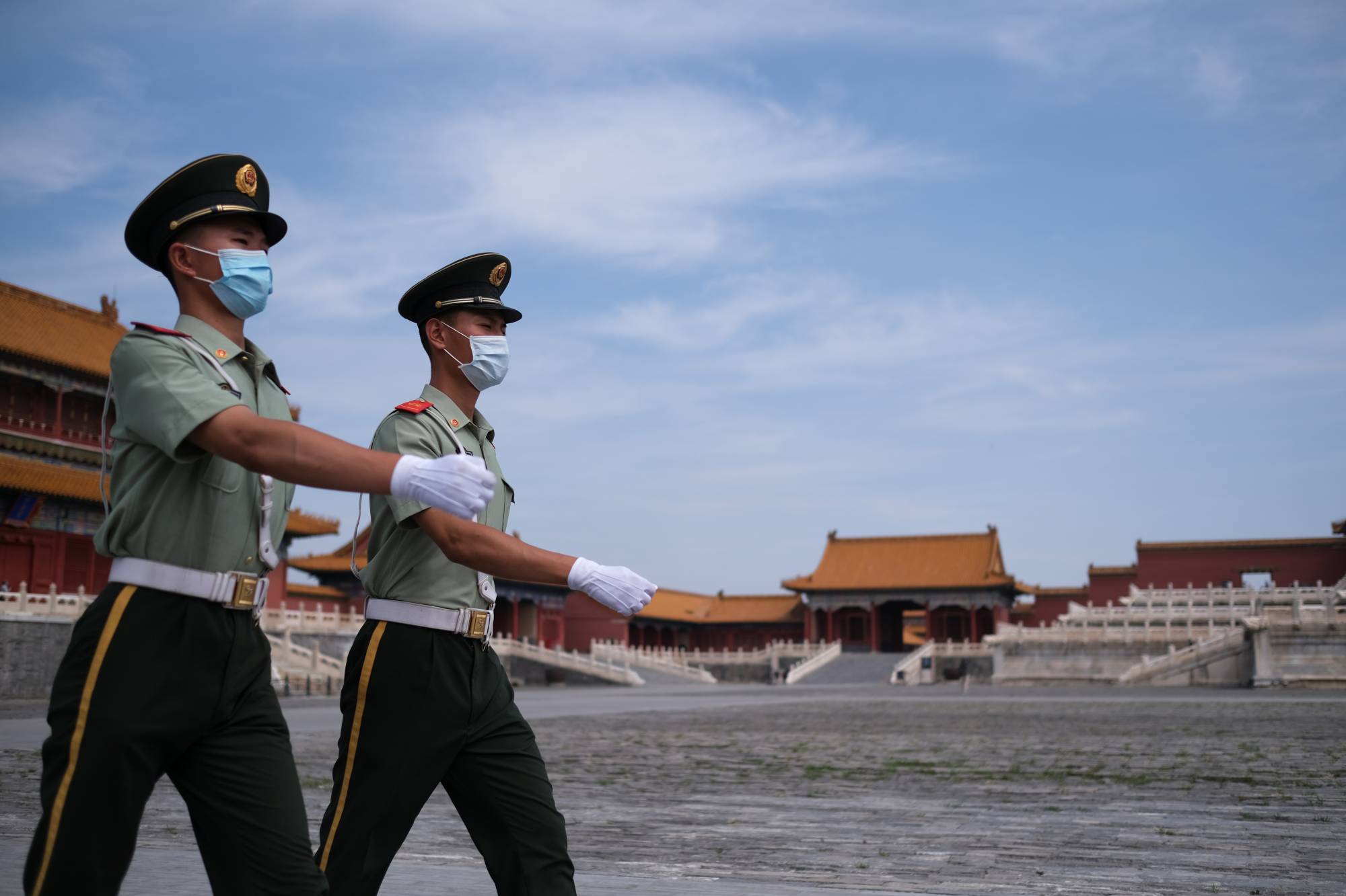 Paramilitary police officers at the Forbidden City in Beijing. An updated espionage law obligates all citizens to report on spying activities and allows authorities to inspect the belongings of suspects. | REUTERS