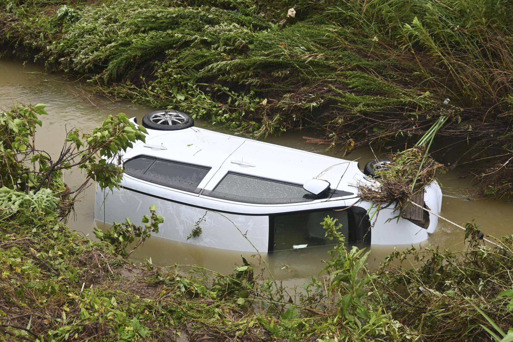 A car that was washed away in Yamaguchi Prefeture on Saturday | KYODO 