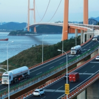Tanker trucks carrying liquefied natural gas cross the Xihoumen Bridge in Zhoushan, China, in 2019 | REUTERS