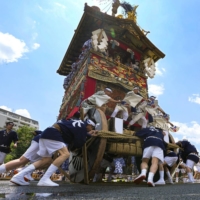 A Yamahoko float is being spun 90 degrees during the Gion Festival last July in Kyoto.  | KYODO 
