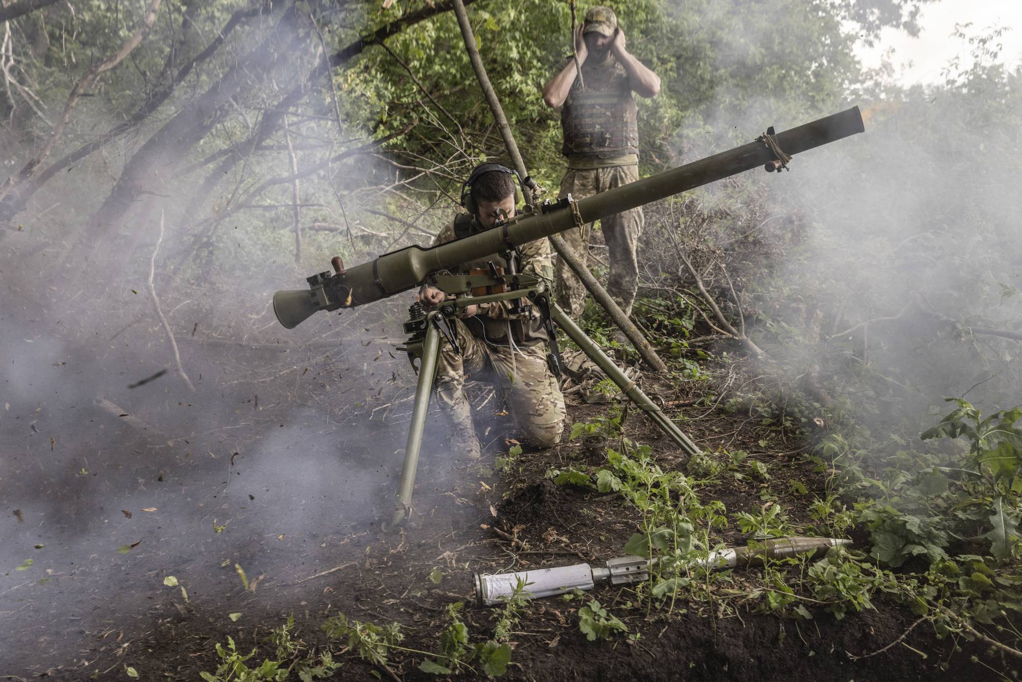 Ukrainian soldiers with the 68th Brigade fire a SPG-9 recoilless gun toward Russian positions near Prechystivka in the Donetsk region of Ukraine. | David Guttenfelder / The New York Times