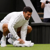 Novak Djokovic\'s Wimbledon first-round match against Pedro Cachin suffers a lengthy rain delay in London on Monday. | REUTERS