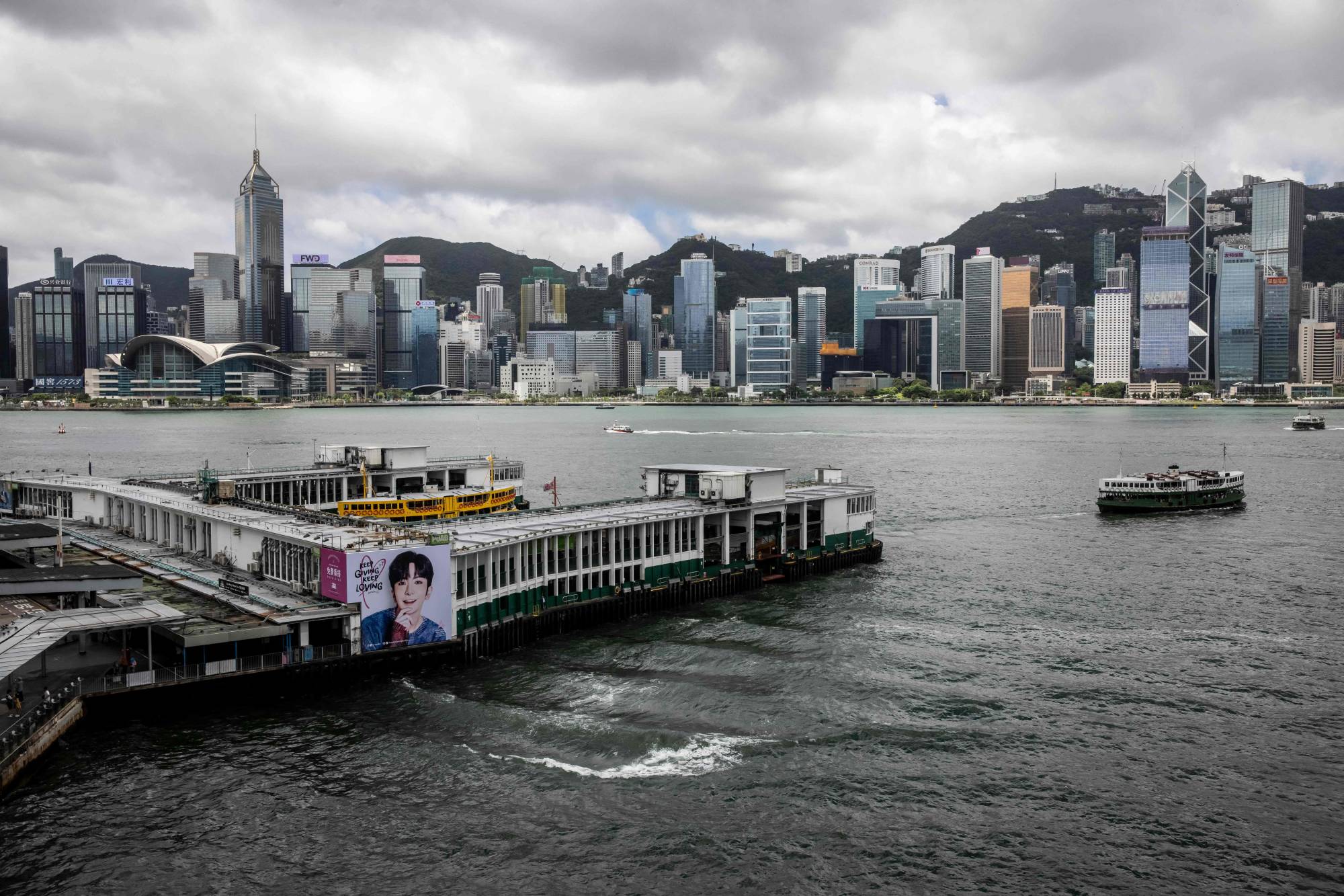 Hong Kong's Victoria Harbor on Tuesday. Stung by a lack of workers, the city has had problems even handling the small numbers of tourists coming in, with reports of mainland tour groups having to eat noodles while standing on the sidewalk. | AFP-JIJI