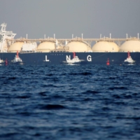 A liquefied natural gas tanker is tugged toward a thermal power station in Futtsu, east of Tokyo, in 2017. | REUTERS