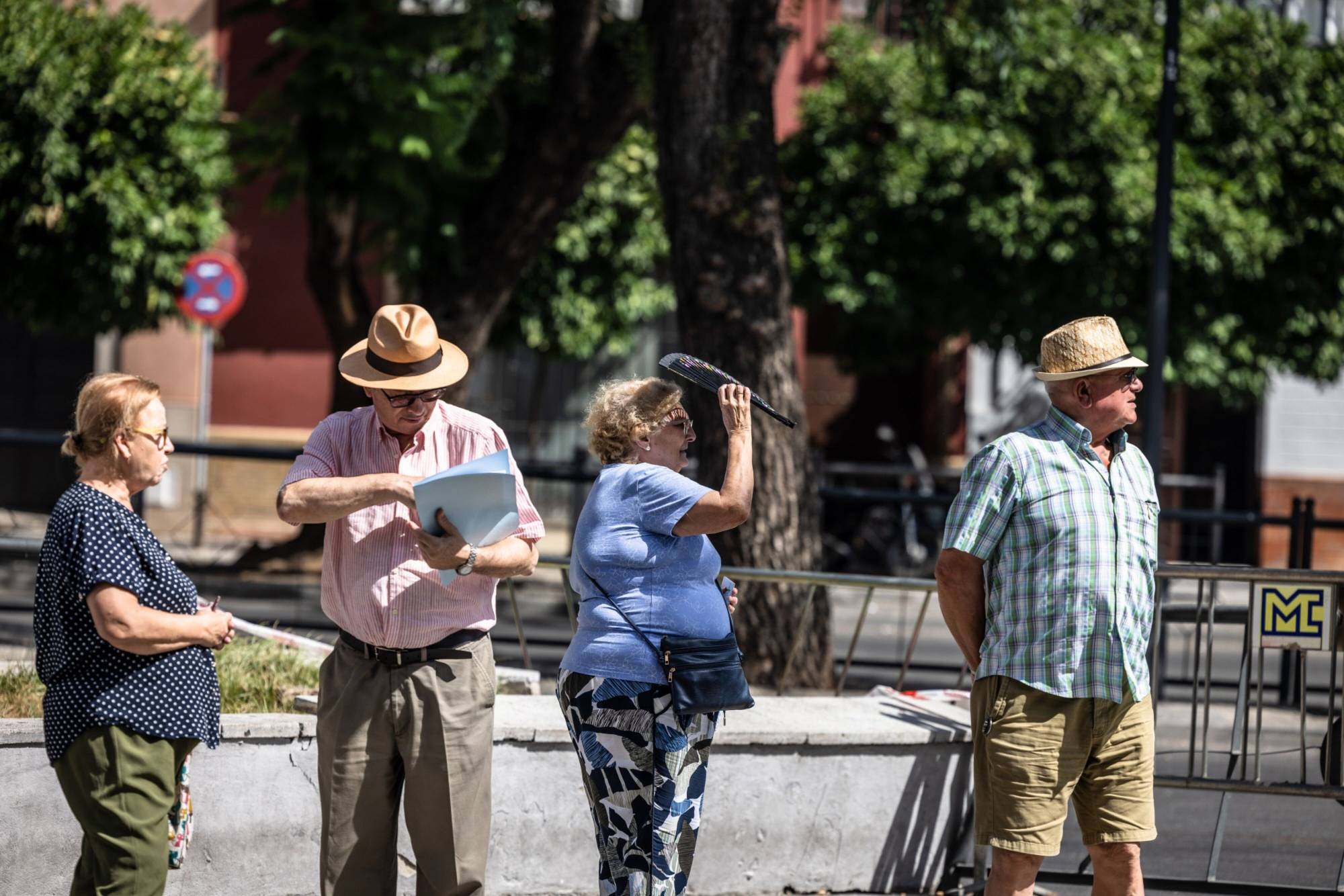 Tourists during high temperatures in the Old Town district of Seville, Spain, on Wednesday. Global temperatures hit a record on Monday, underscoring the dangers of ever-increasing greenhouse gas emissions generated from burning fossil fuels. | BLOOMBERG