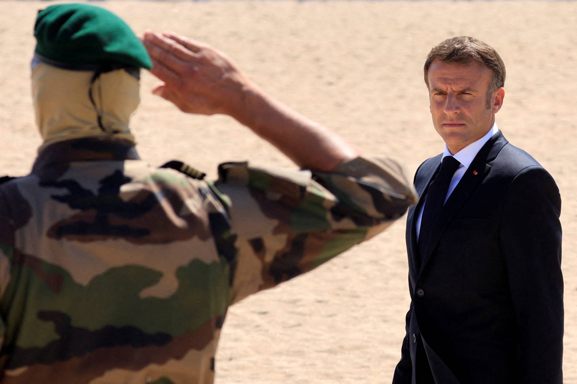 French President Emmanuel Macron reviews troops of the Commando Marine Special forces of the French Navy during a ceremony on the beach in Ouistreham, Normandy, on Friday.  | POOL / VIA AFP-JIJI