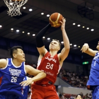 Japan\'s Josh Hawkinson (24) is covered by two Taiwan players Saturday during the first quarter of Japan\'s 108-86 win.  | KYODO 