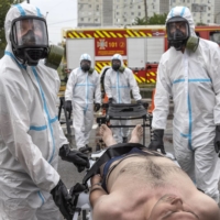 Ukrainian emergency workers take part in a drill simulating a nuclear disaster in Zaporizhzhia, Ukraine, on June 29.   | DAVID GUTTENFELDER / THE NEW YORK TIMES