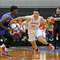 Japan\'s Keisei Tominaga (right) attacks the Taiwan basket during the second quarter of a FIBA World Cup warmup match at Hamamatsu Arena in Shizuoka Prefecture on Sunday. | KYODO