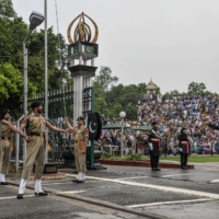 A security force on the Indian side of the Attari-Wagah border post, with Pakistani forces in the background, near Amritsar, India. In both countries, interfaith relations have become somewhat of a minefield. | ATUL LOKE / THE NEW YORK TIMES