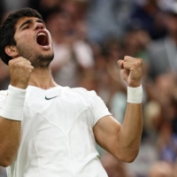 World No. 1 Carlos Alcaraz celebrates after beating Matteo Berrettini in their Wimbledon fourth-round men\'s singles match in London on Tuesday. | AFP-JIJI