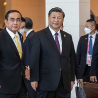 Thai Prime Minister Prayuth Chan-ocha (left) arrives with Chinese leader Xi Jinping at the Asia-Pacific Economic Cooperation summit in Bangkok in November.  | BLOOMBERG
