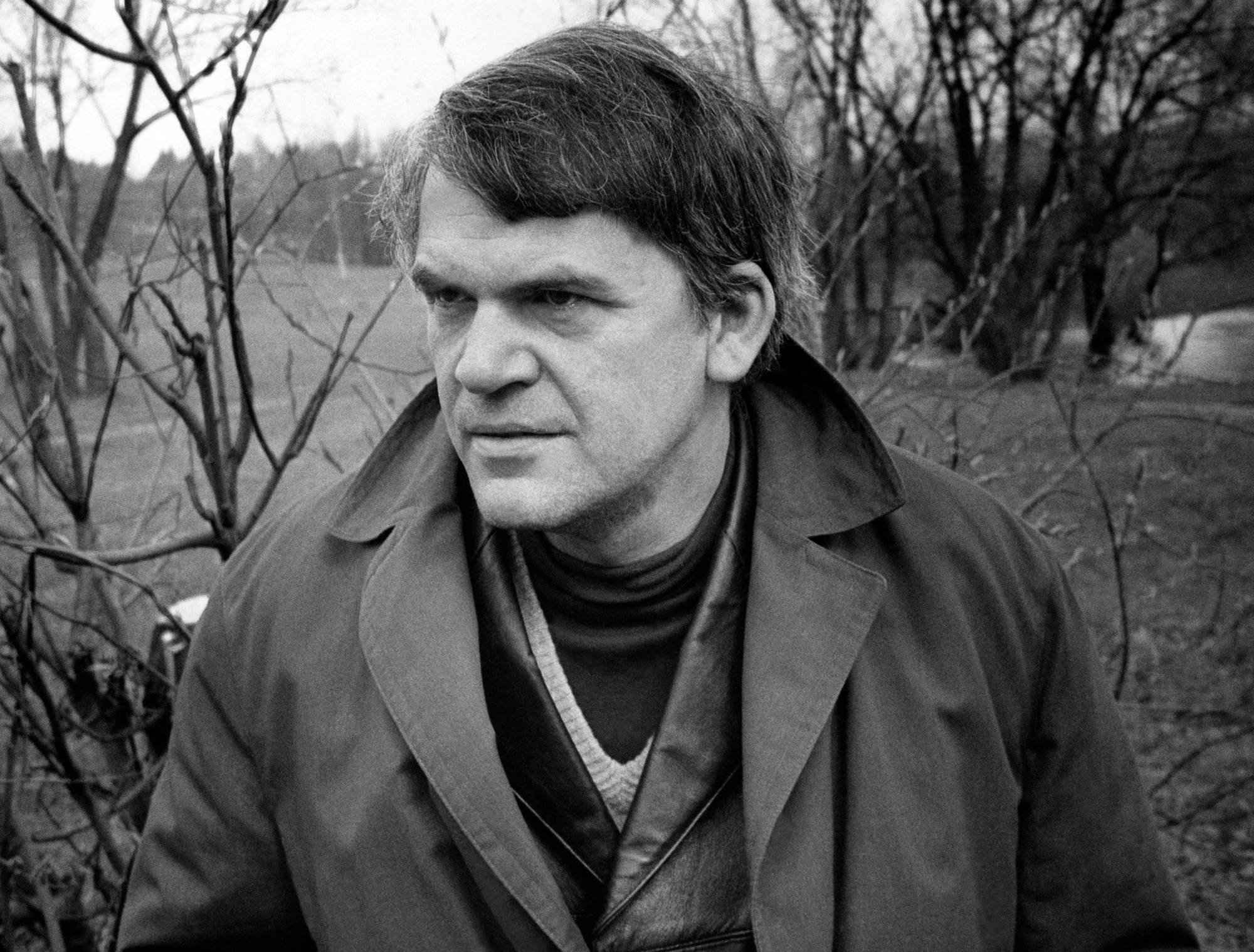 Czech writer Milan Kundera poses in a garden in Prague in October 1973. The author has died at the age of 94, it was announced on Wednesday. | AFP-JIJI