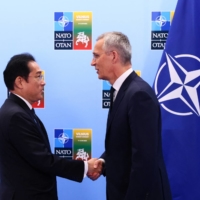 Prime Minister Fumio Kishida and NATO Secretary-General Jens Stoltenberg meet during a NATO summit in Vilnius, Lithuania, on Wednesday. | REUTERS