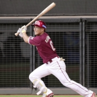 The Eagles\' Hiroto Kobukata drives in the go-ahead run in the top of the ninth against the Fighters in Kitahiroshima, Hokkaido, on Thursday. | KYODO