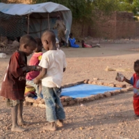 Internally displaced Sudanese children play at a make-shift refugee camp on Monday. | AFP-JIJI
