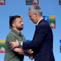 Ukrainian President Volodymyr Zelenskyy and NATO Secretary-General Jens Stoltenberg shake hands at a news conference during a NATO leaders summit in Vilnius, Lithuania, on Wednesday. | REUTERS