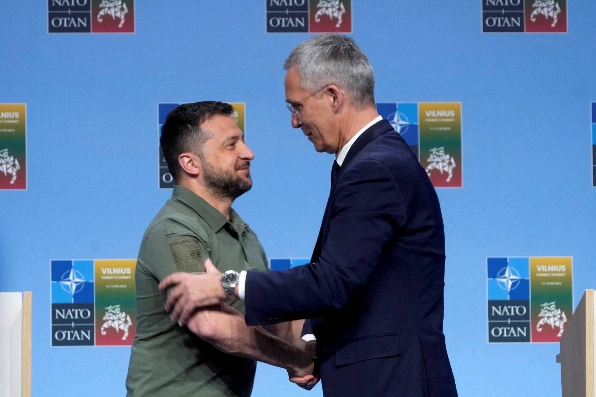 Ukrainian President Volodymyr Zelenskyy and NATO Secretary-General Jens Stoltenberg shake hands at a news conference during a NATO leaders summit in Vilnius, Lithuania, on Wednesday. | REUTERS
