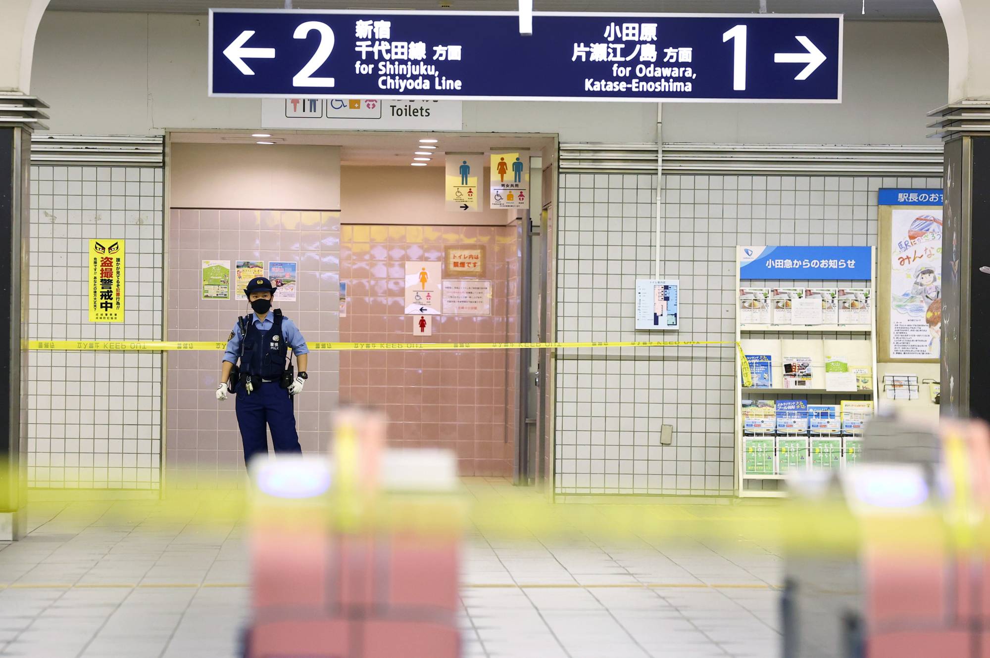 A police officer stands guard at Soshigaya-Okura Station in Tokyo's Setagaya Ward on Aug. 6, 2021, following a stabbing incident on a train.  | REUTERS